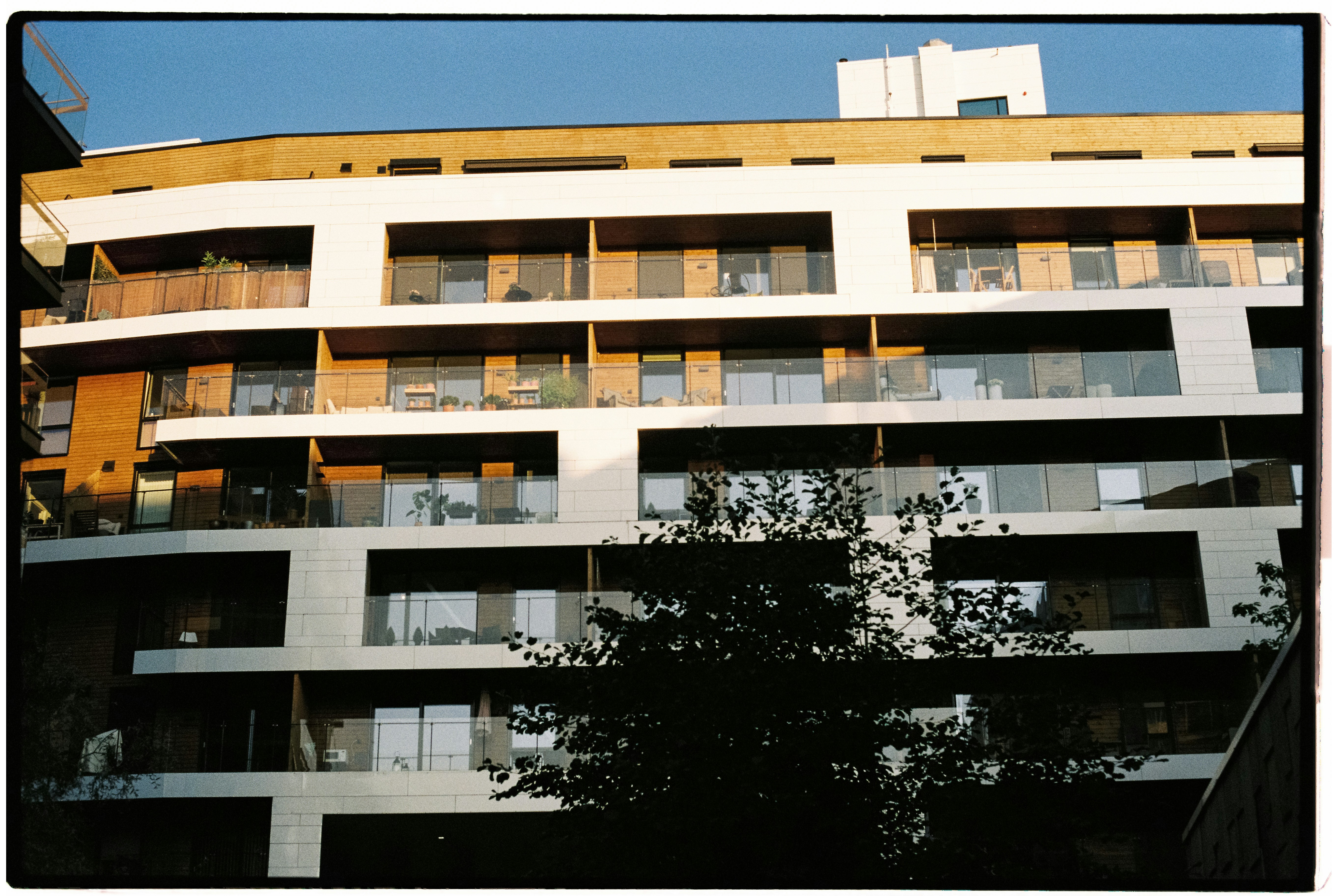 A tall building with balconies and balconies on top