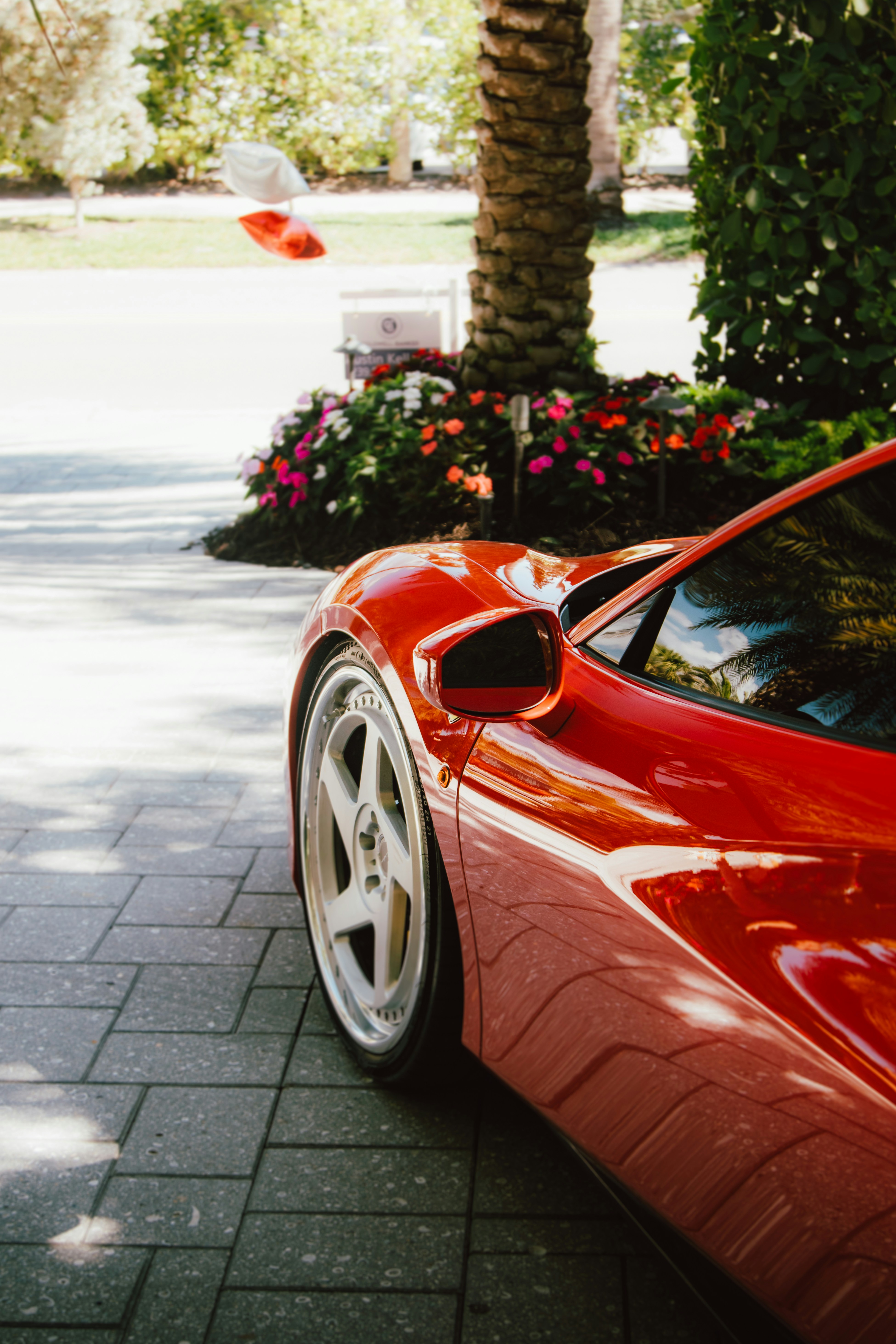 A red sports car parked on the side of the road