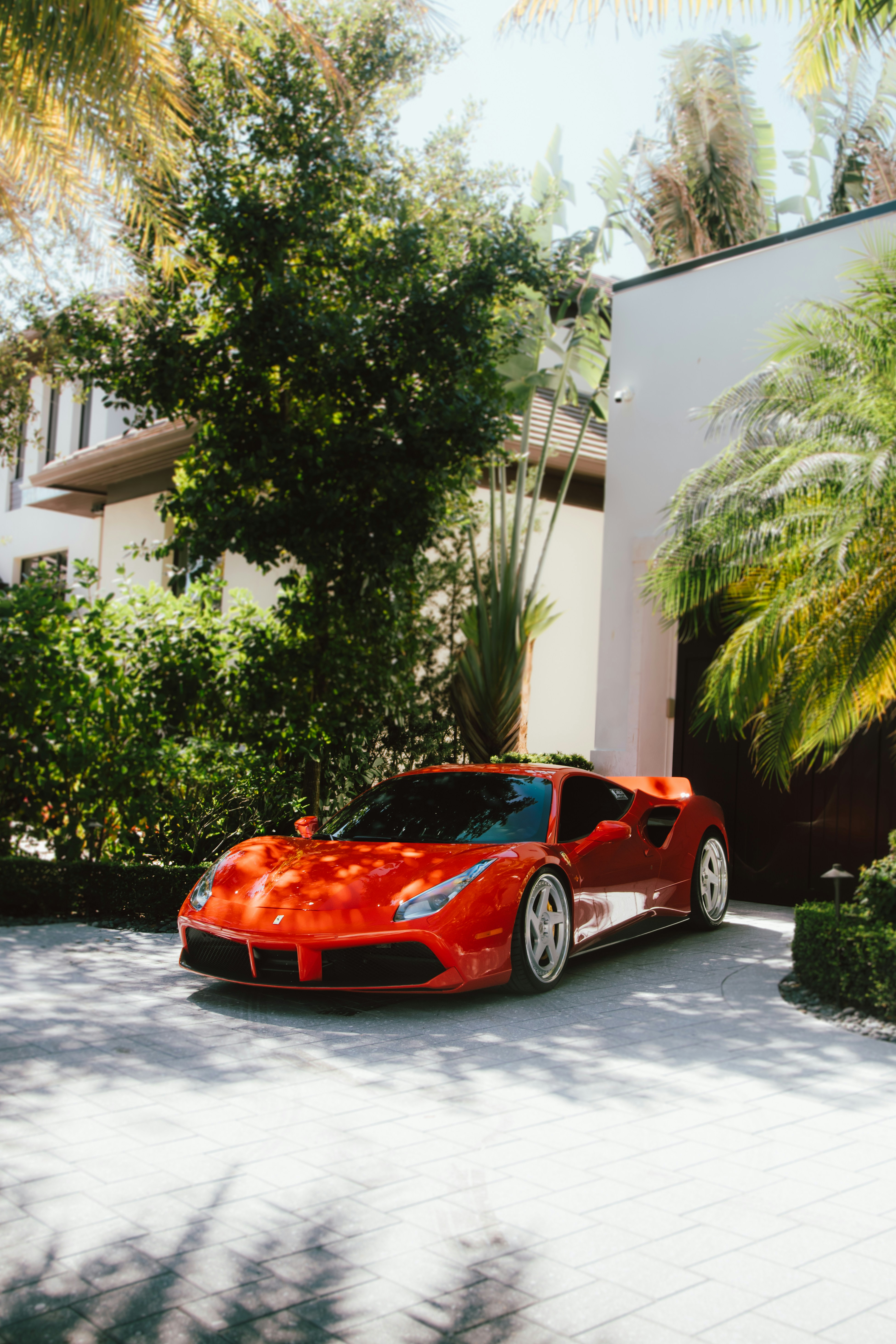 A red sports car parked in front of a house