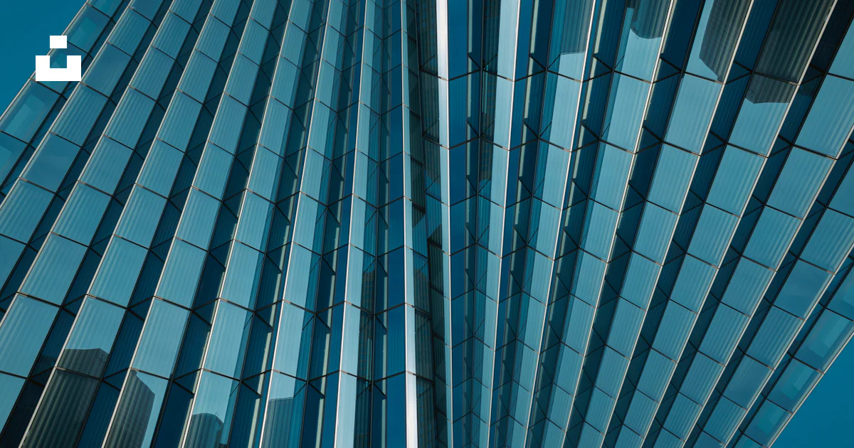 A close up of a tall building with many windows photo – Free Abstract ...
