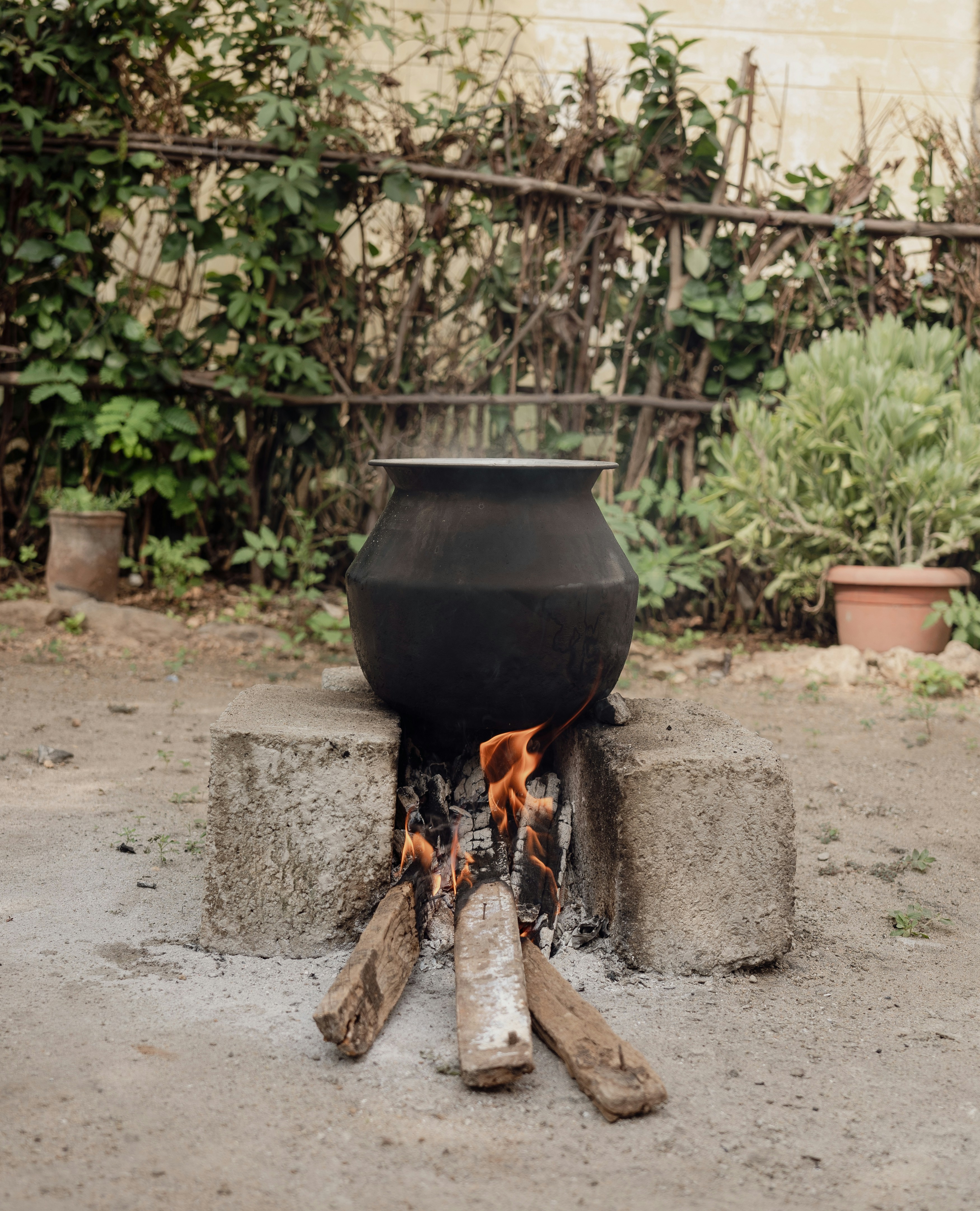 A black pot sitting on top of a fire pit