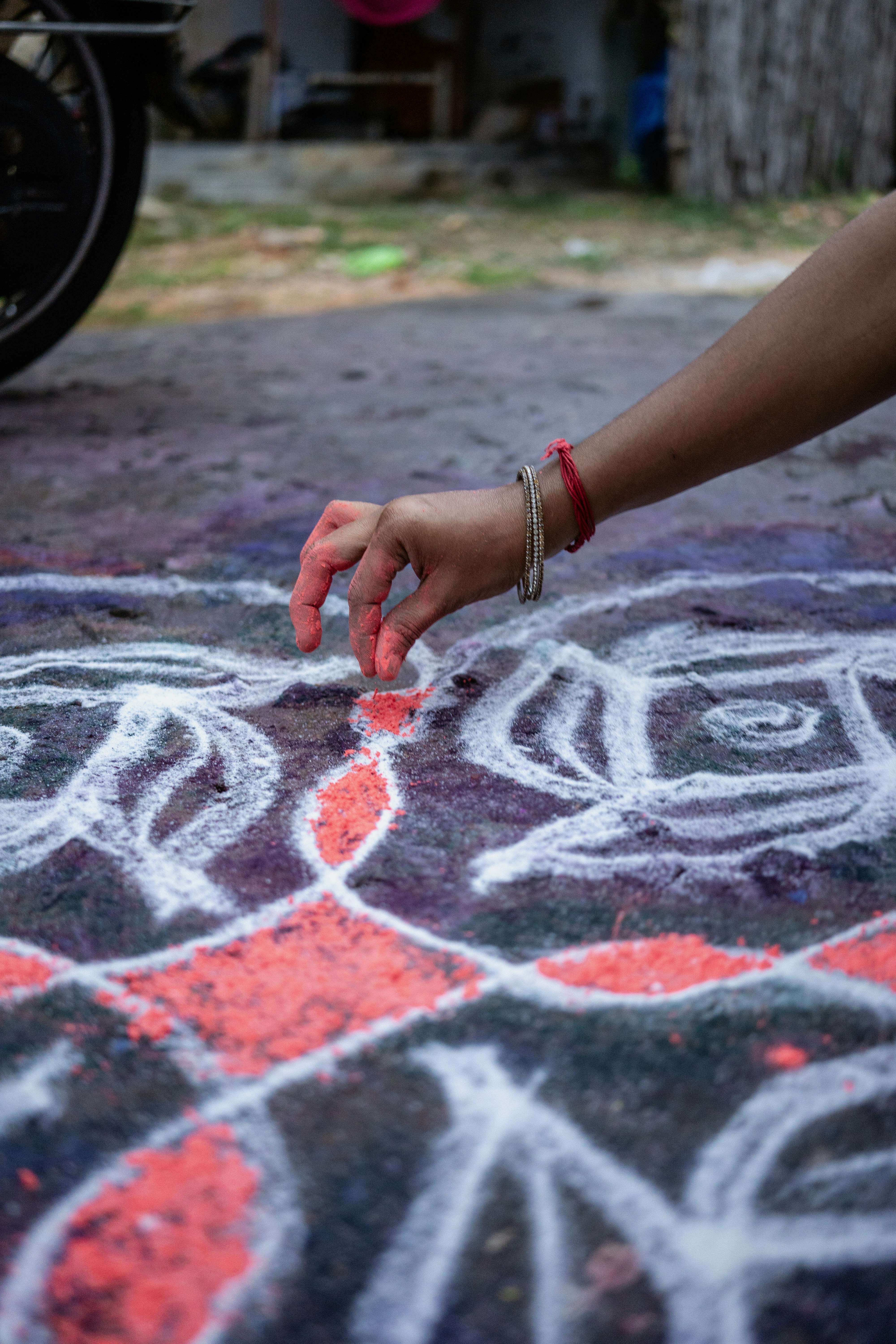 A person drawing on the ground with chalk