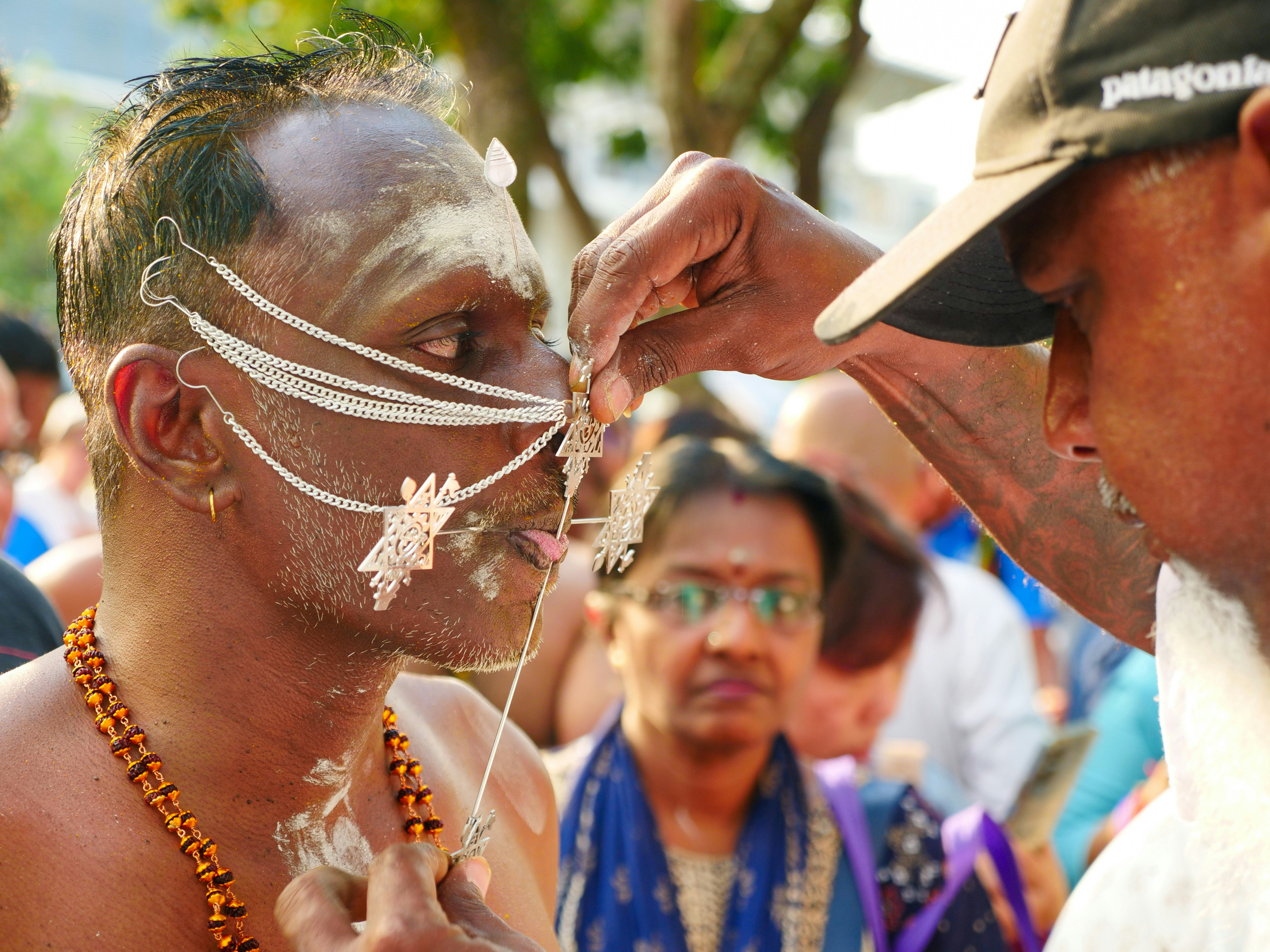 A man with white paint on his face and neck