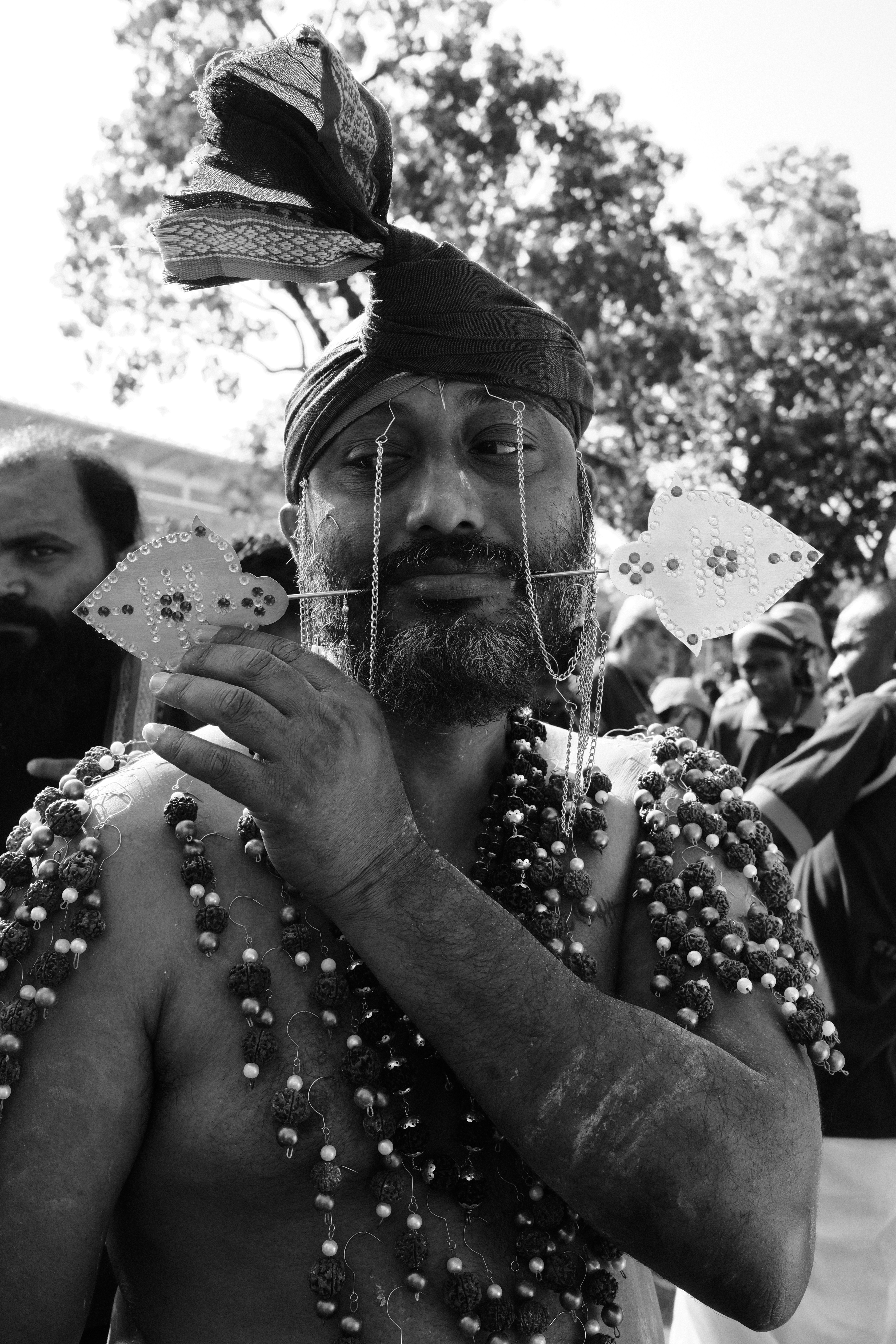 A man in a headdress is holding something in his hands