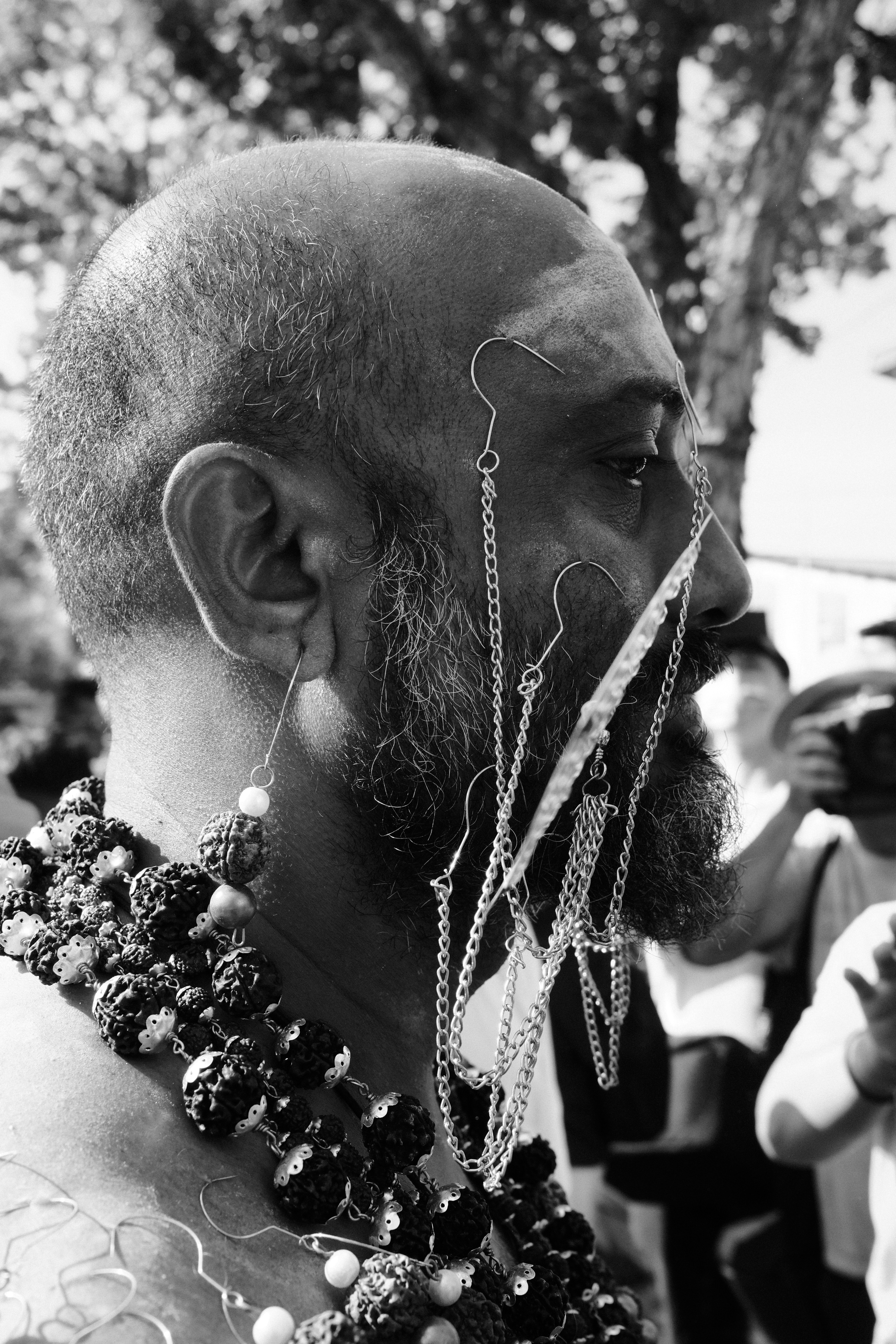 A man with a beard wearing a chain around his neck