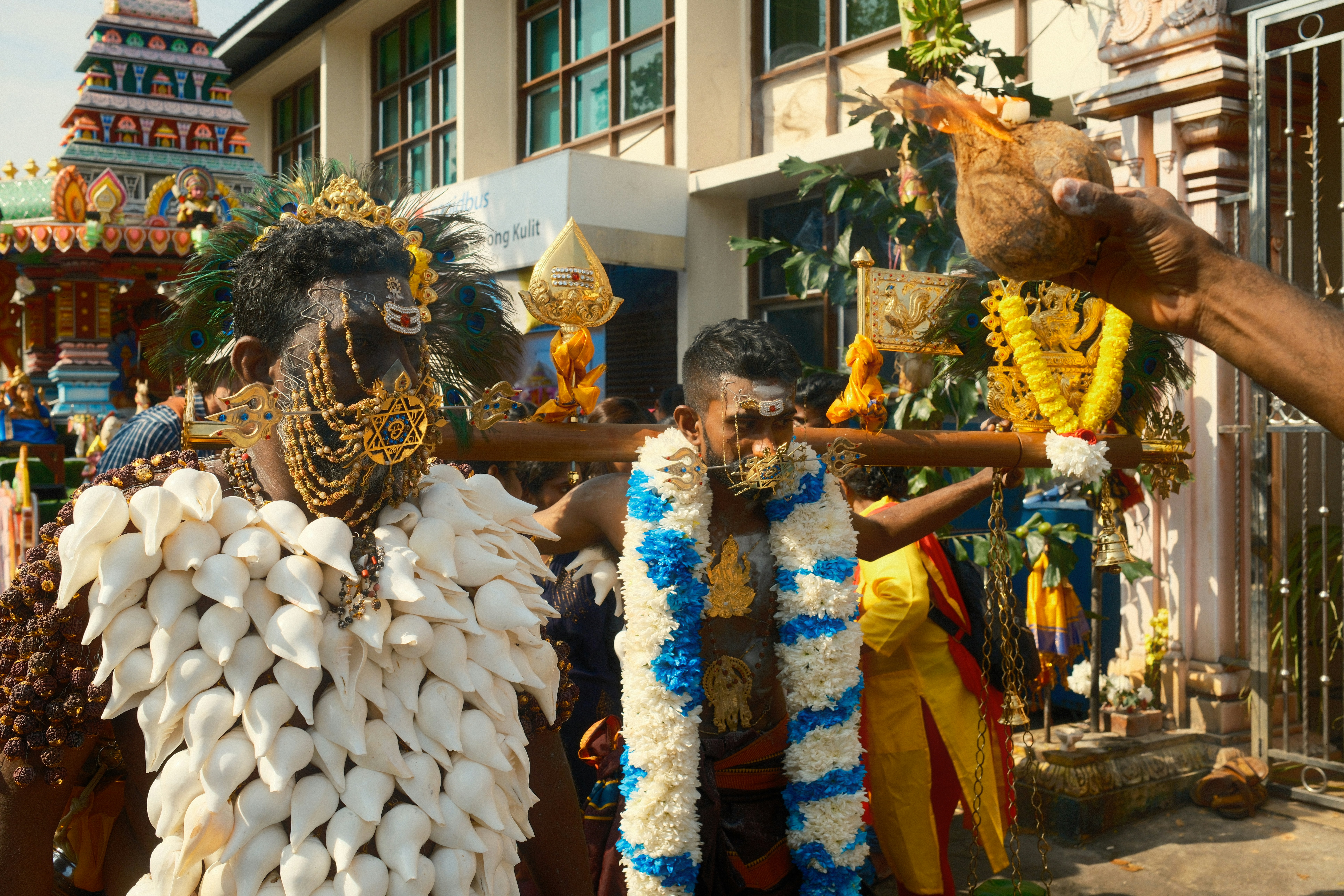 A group of people standing around each other in front of a building