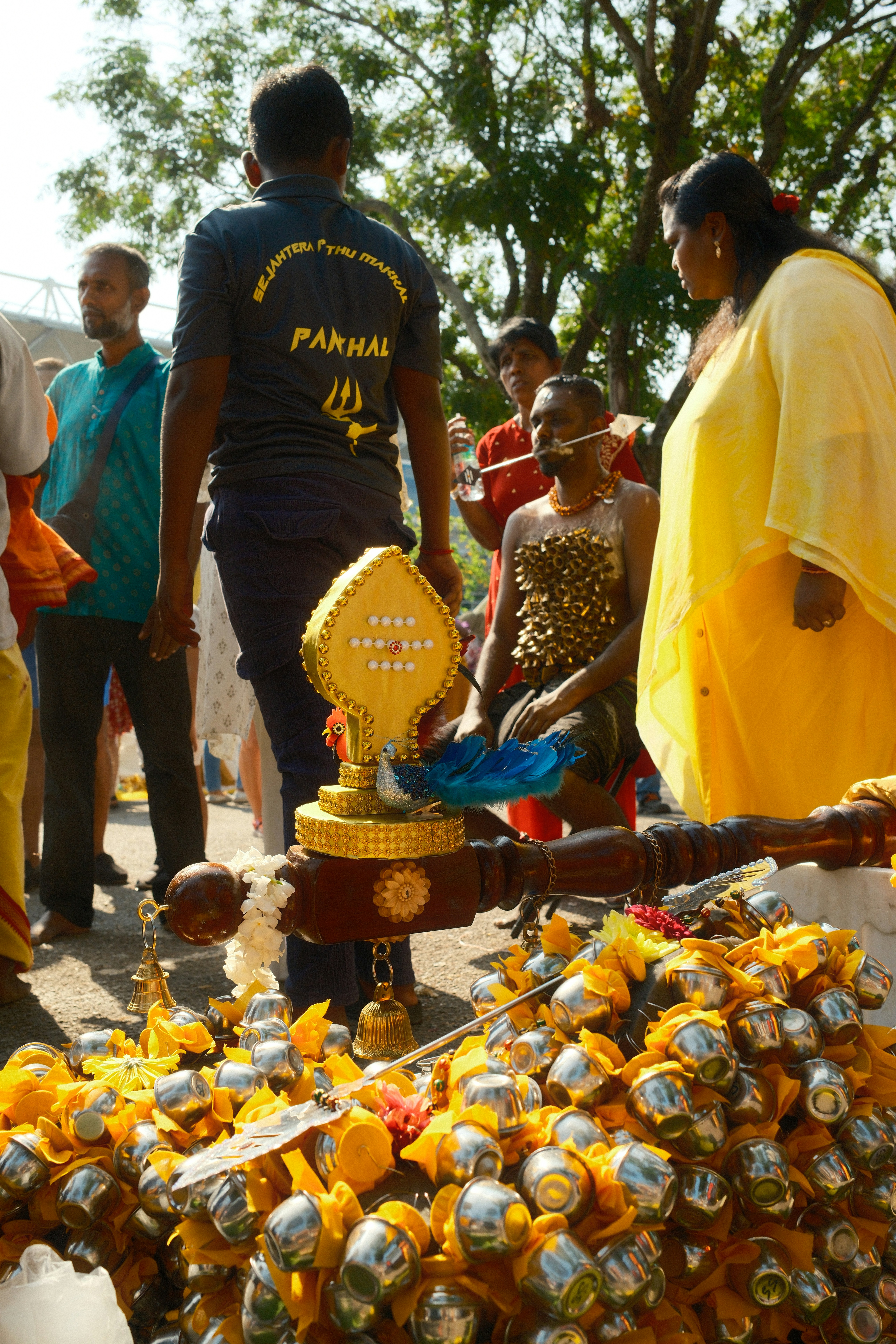 A group of people standing around a bunch of items