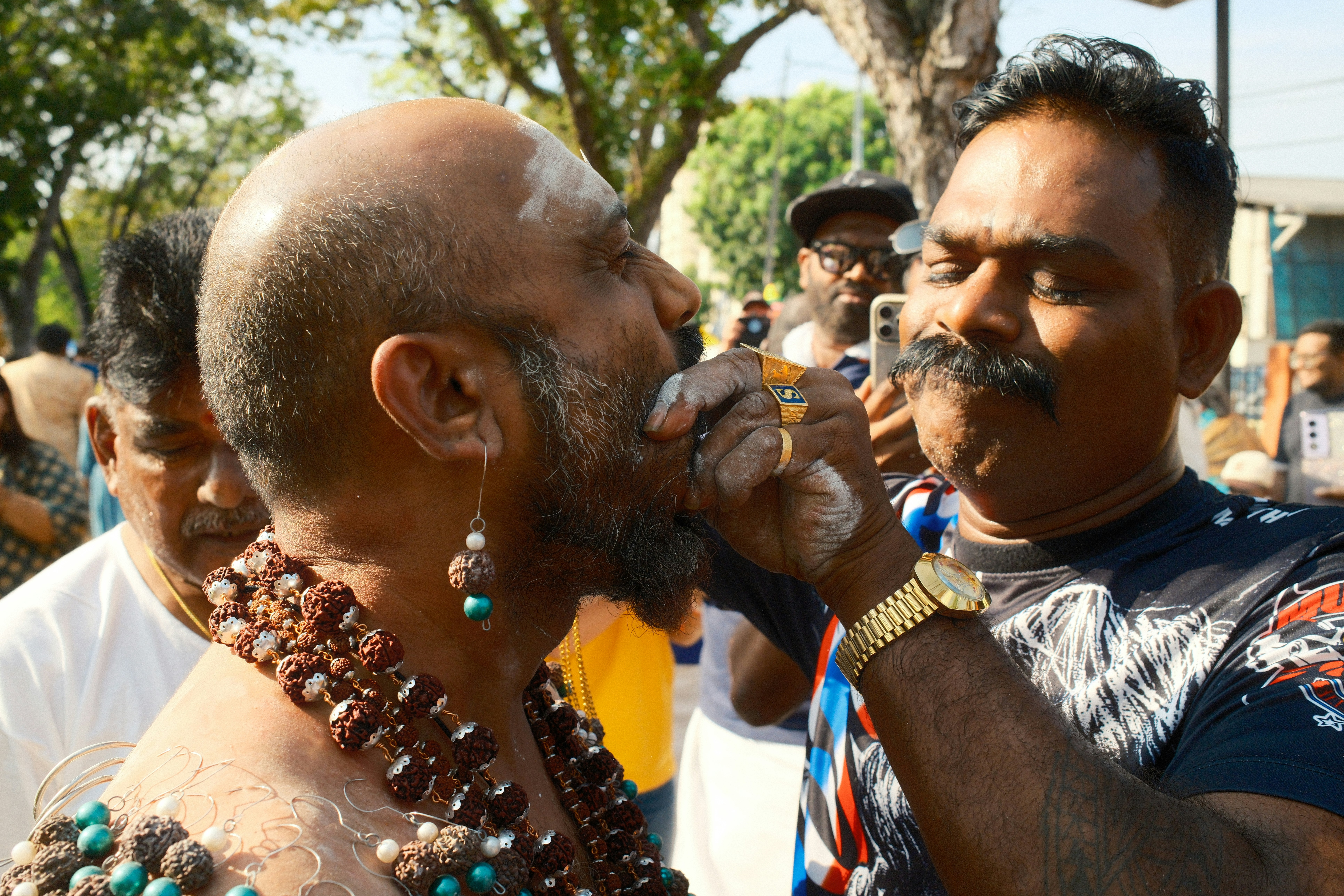 A group of men standing around each other