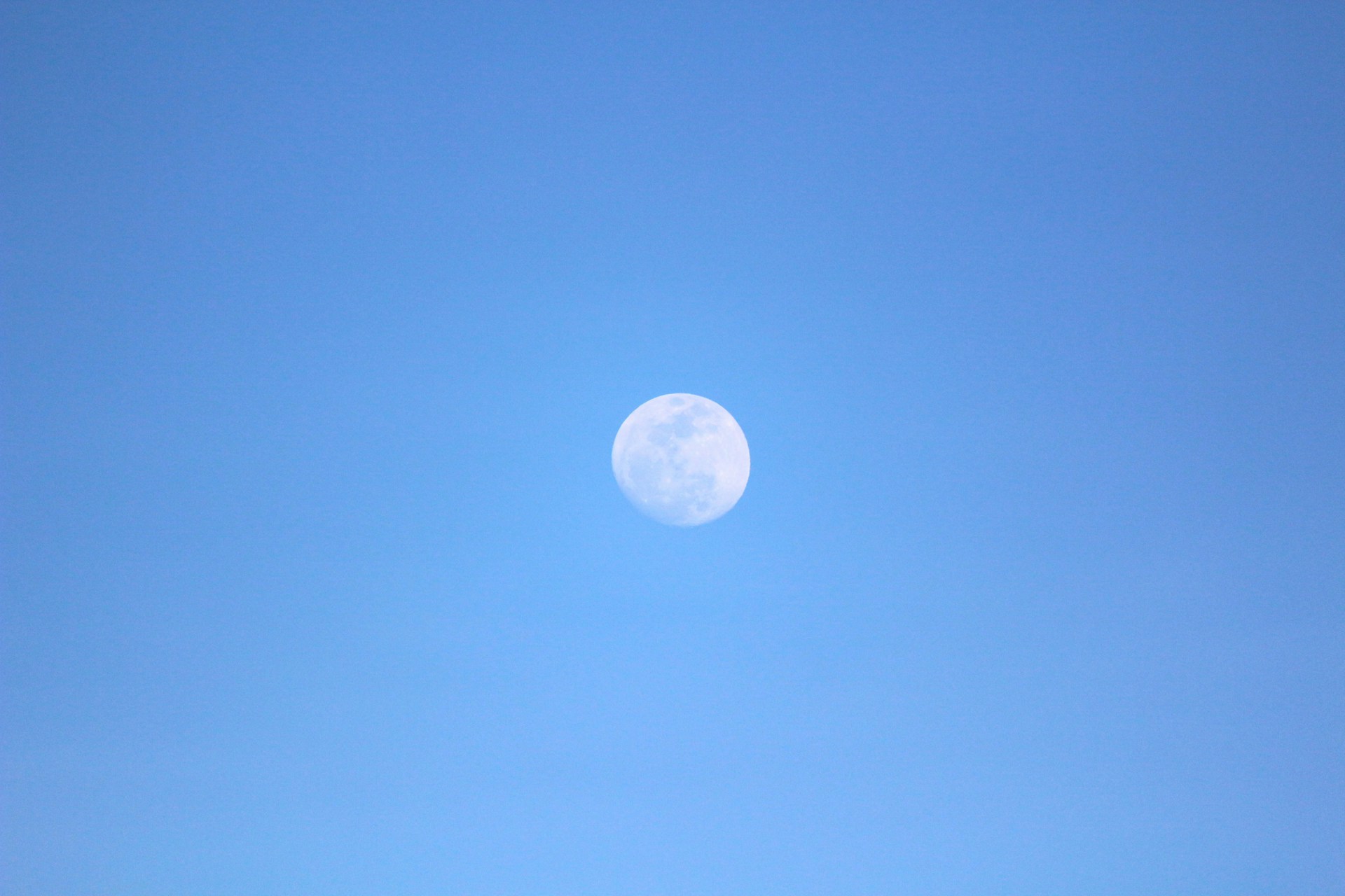 A group of people standing on top of a sandy beach