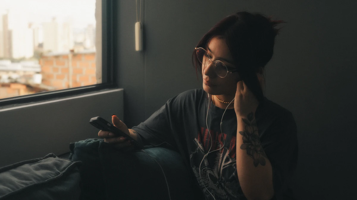 Woman on the couch smiling at a message on her phone