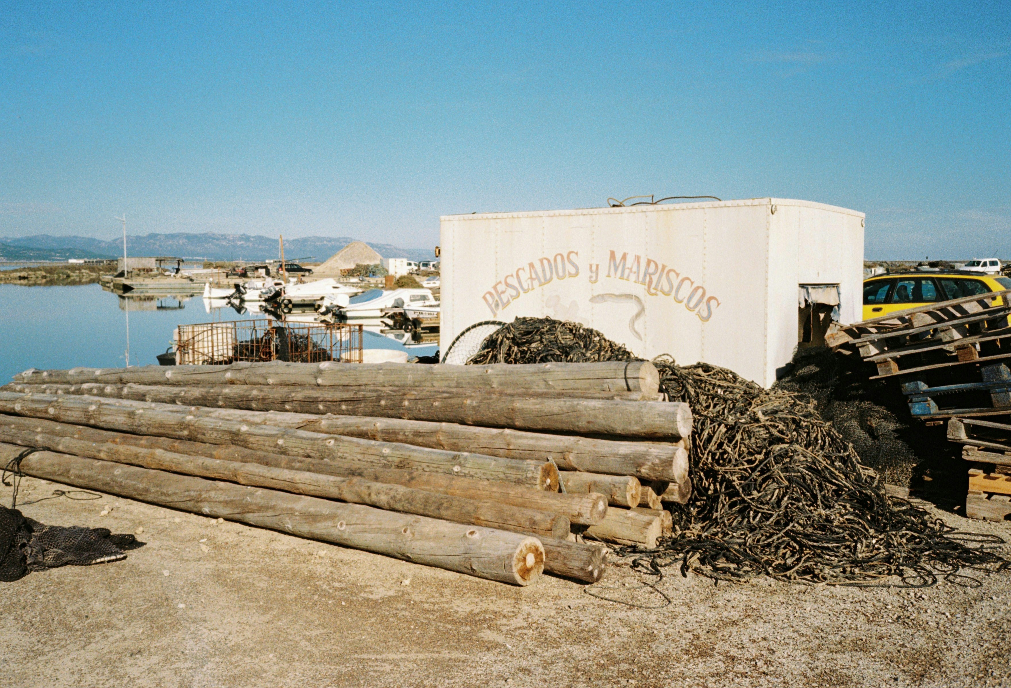 A pile of wood sitting next to a body of water
