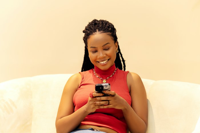Free romantic chat room — woman smiling while chatting on AimerWorld