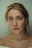 A woman with blue eyes is looking at the camera