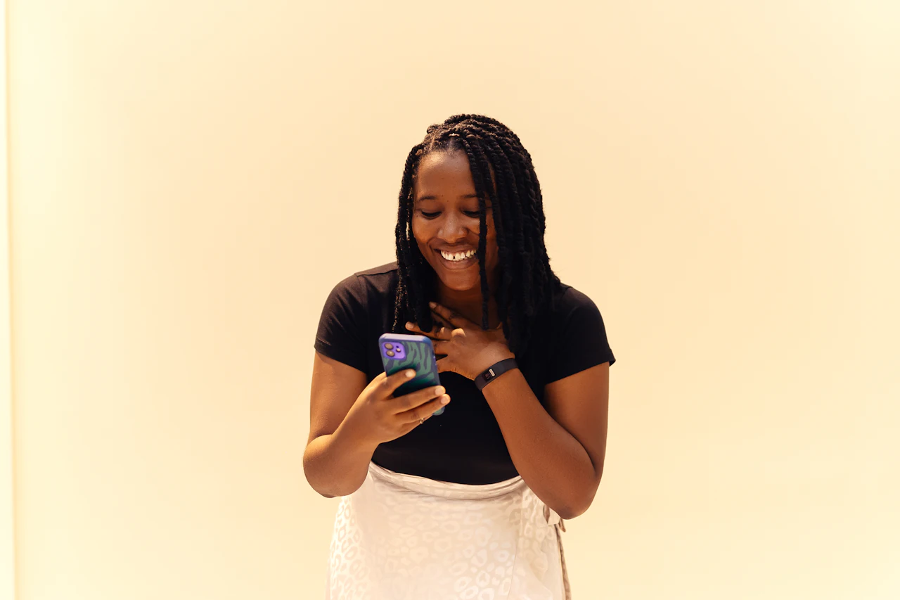 A smiling woman listening on her phone