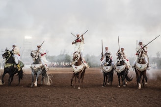 A group of men riding on the backs of horses