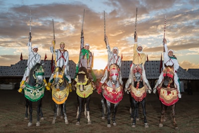 A group of people riding on the backs of horses