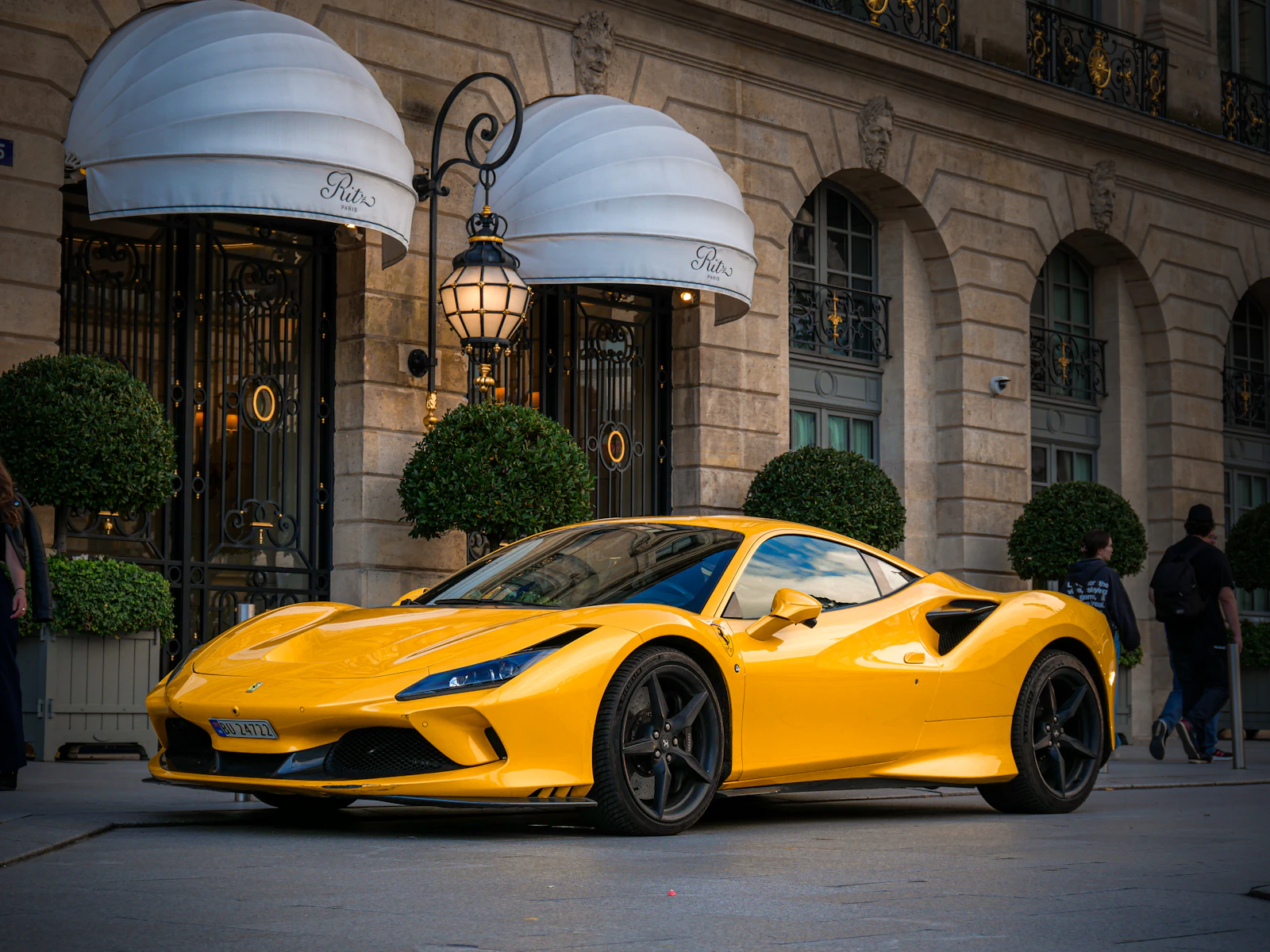 Yellow Ferrari F8 Tributo parked outside a hotel entrance
