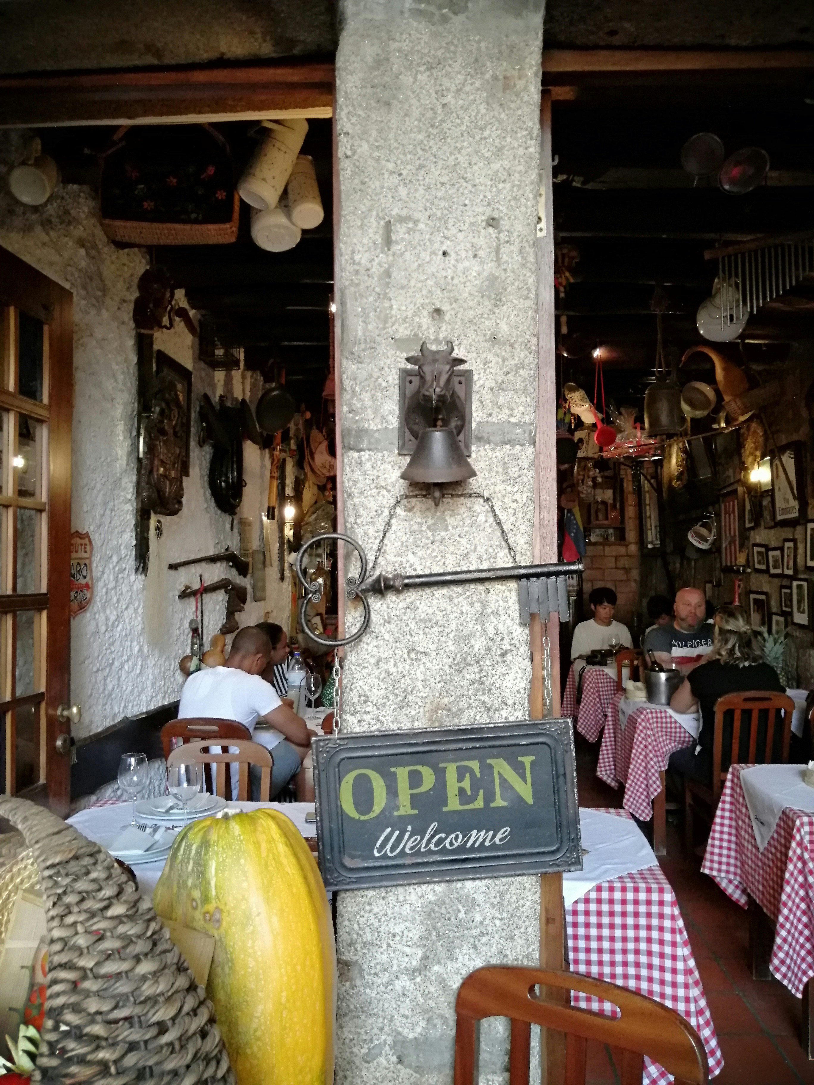 A group of people sitting at a table in a restaurant