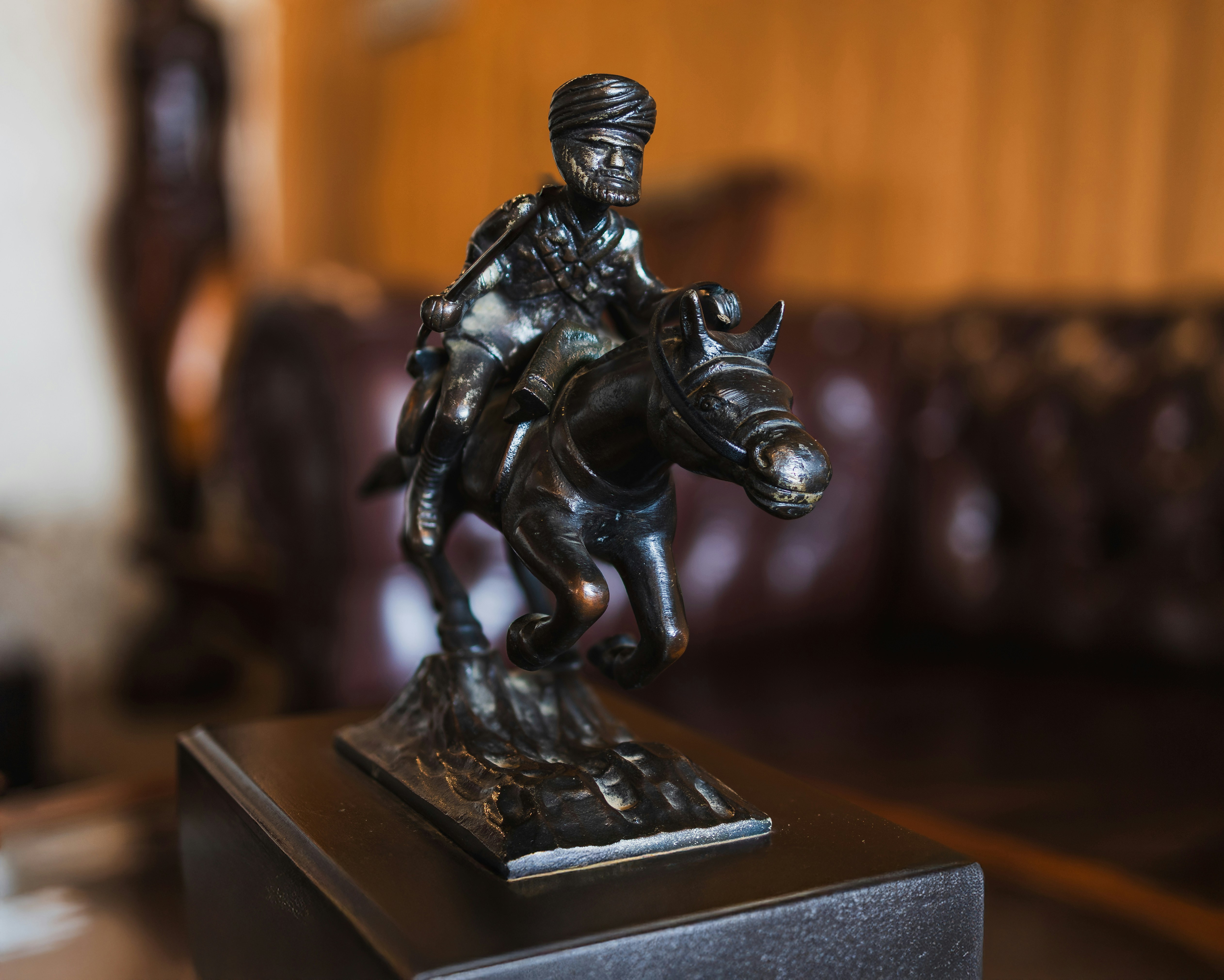 A bronze statue of a man riding a horse