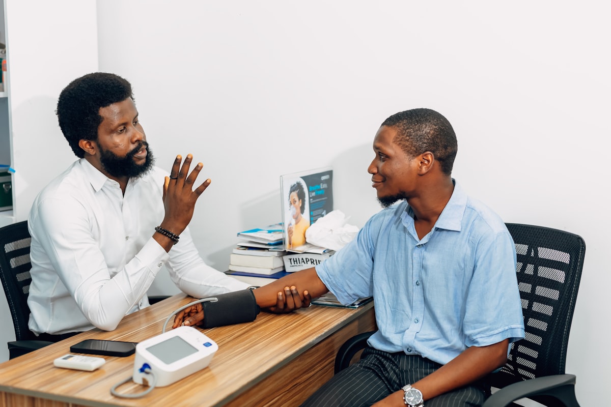 A doctor and a patient sitting across a desk during a consultation
