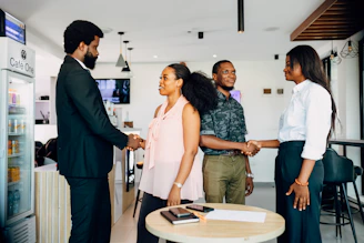 A group of people shaking hands in a room