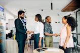 A group of people shaking hands in a room