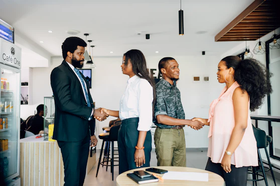 A group of people shaking hands in a room