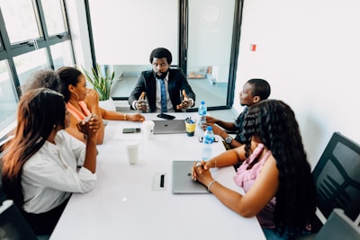 A group of people sitting around a white table