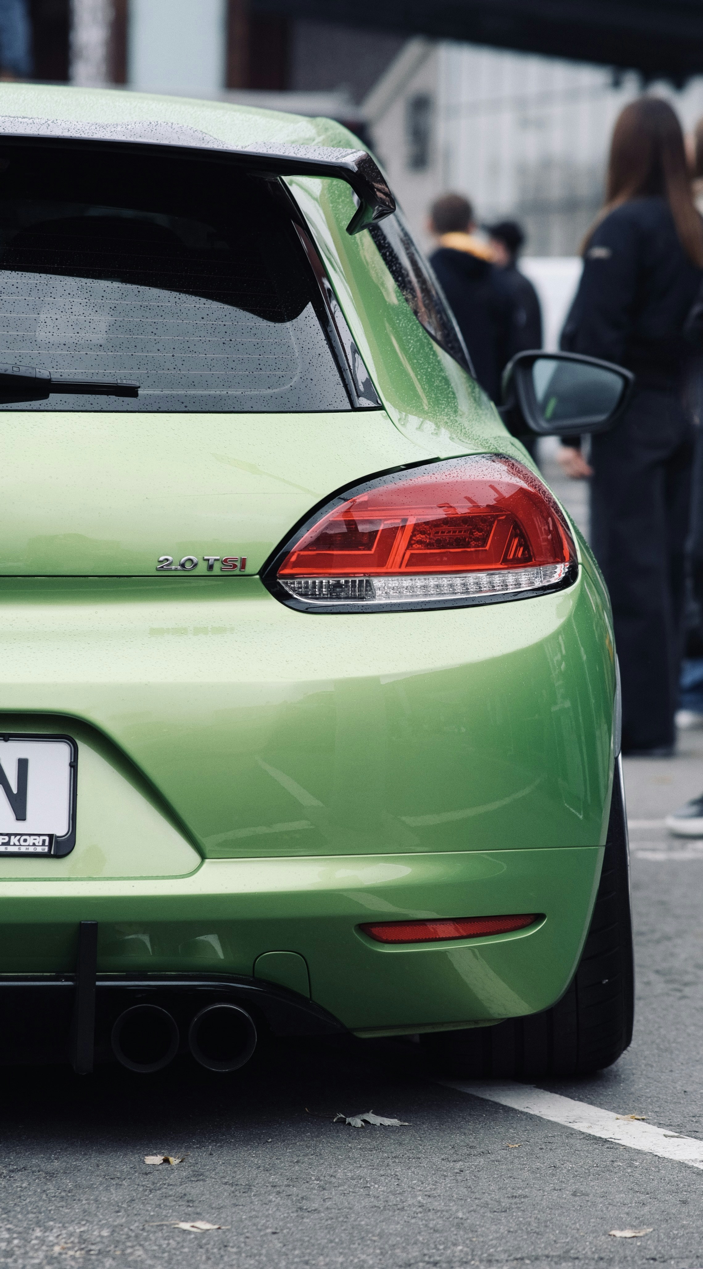 A green sports car parked in a parking lot