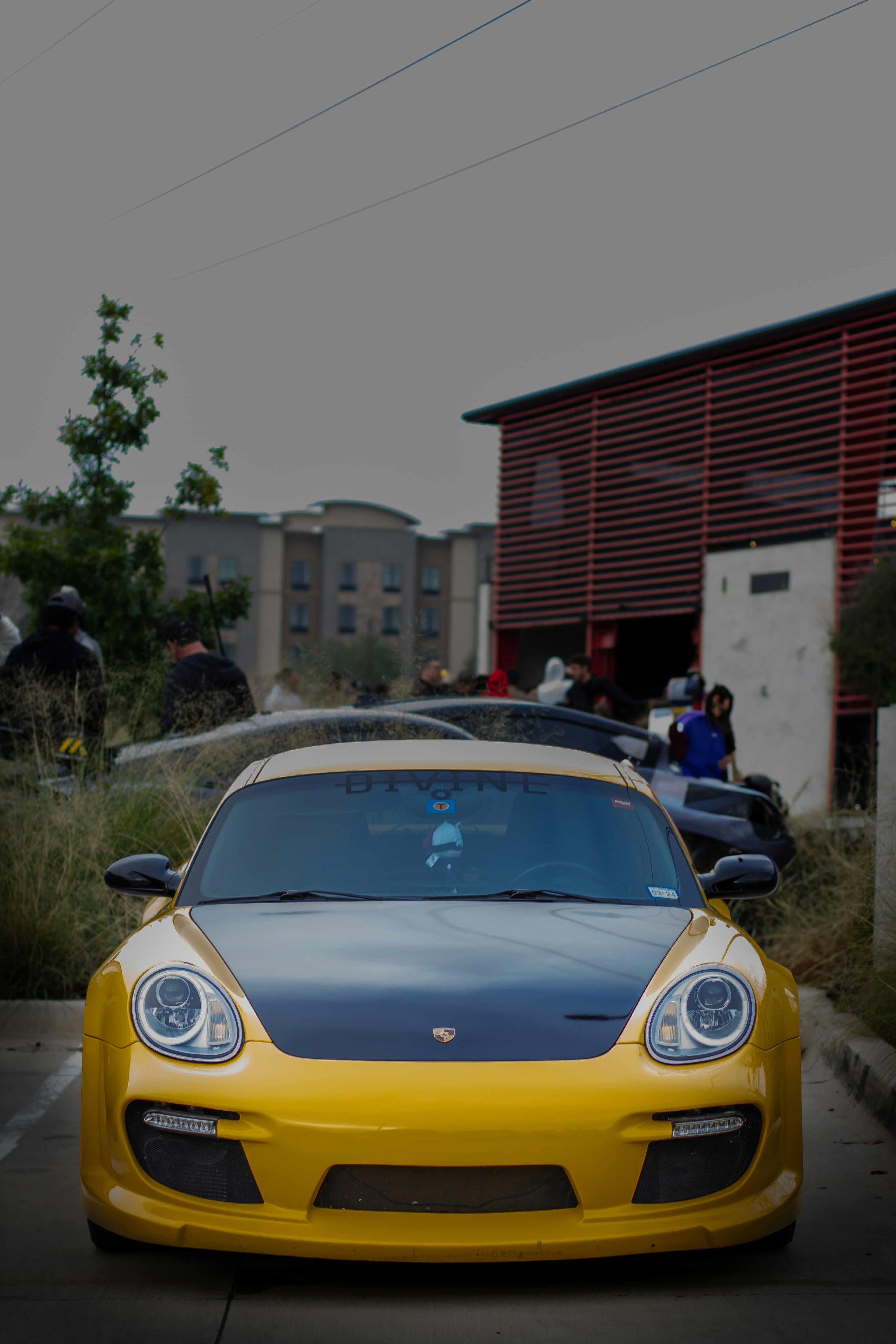 A yellow sports car parked in a parking lot