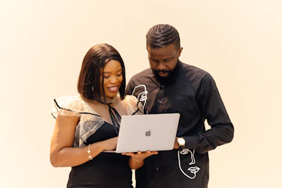 A man and a woman looking at a laptop