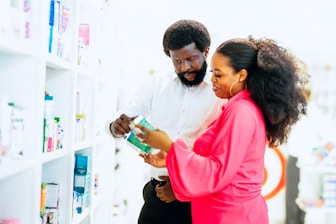 A man and a woman looking at items in a store