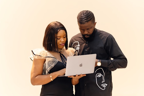 A man and a woman looking at a laptop