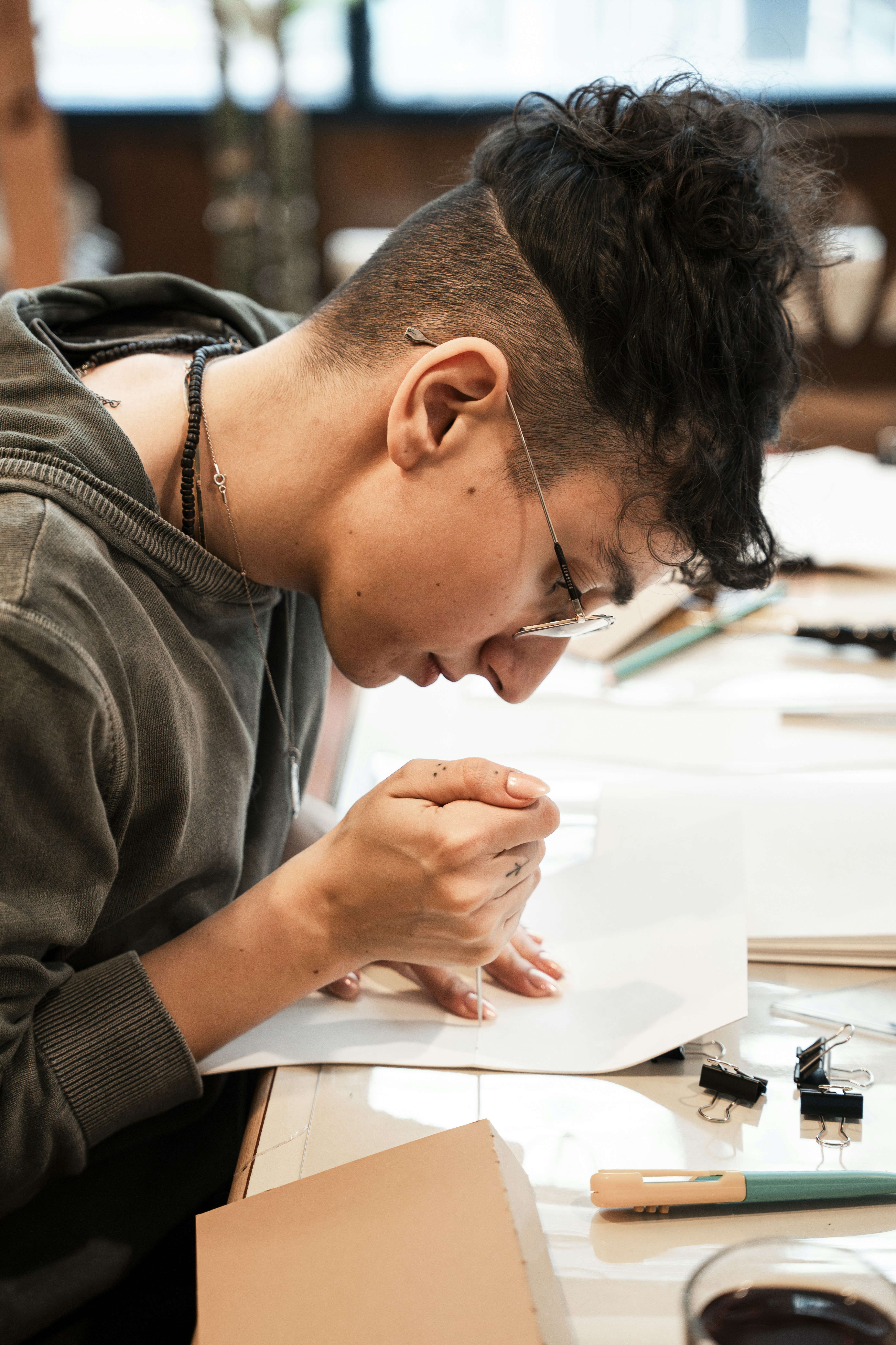 A man looking at a piece of paper on a table