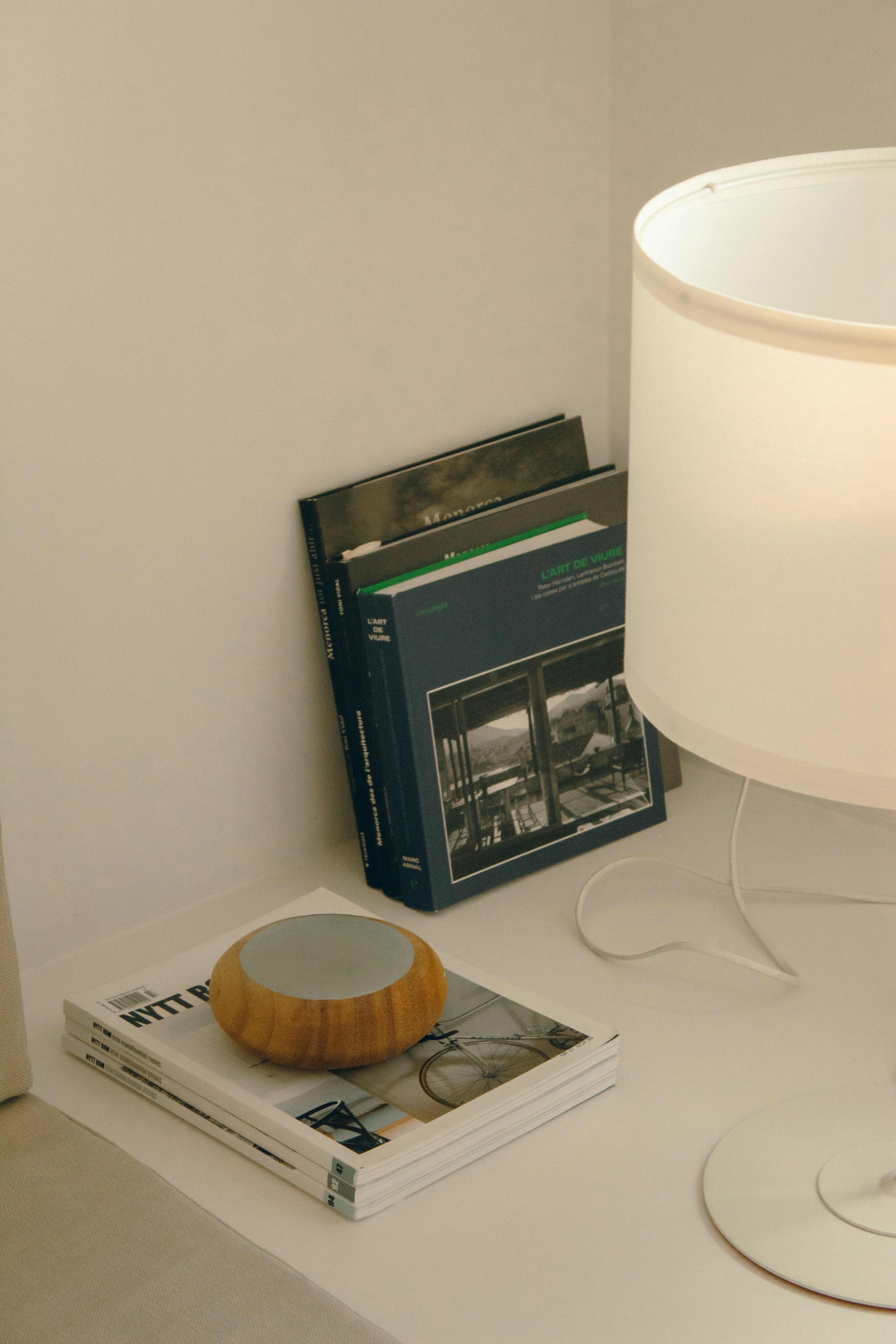 A table with a lamp and a book on it