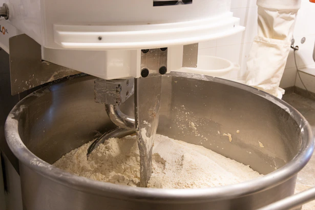 A mixer mixing a mixture in a bowl