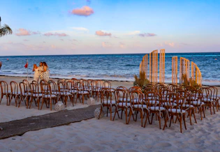 A bunch of chairs sitting on top of a sandy beach