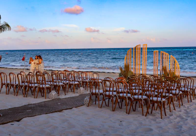 A bunch of chairs sitting on top of a sandy beach