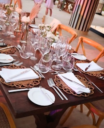 A long table with a lot of place settings on it