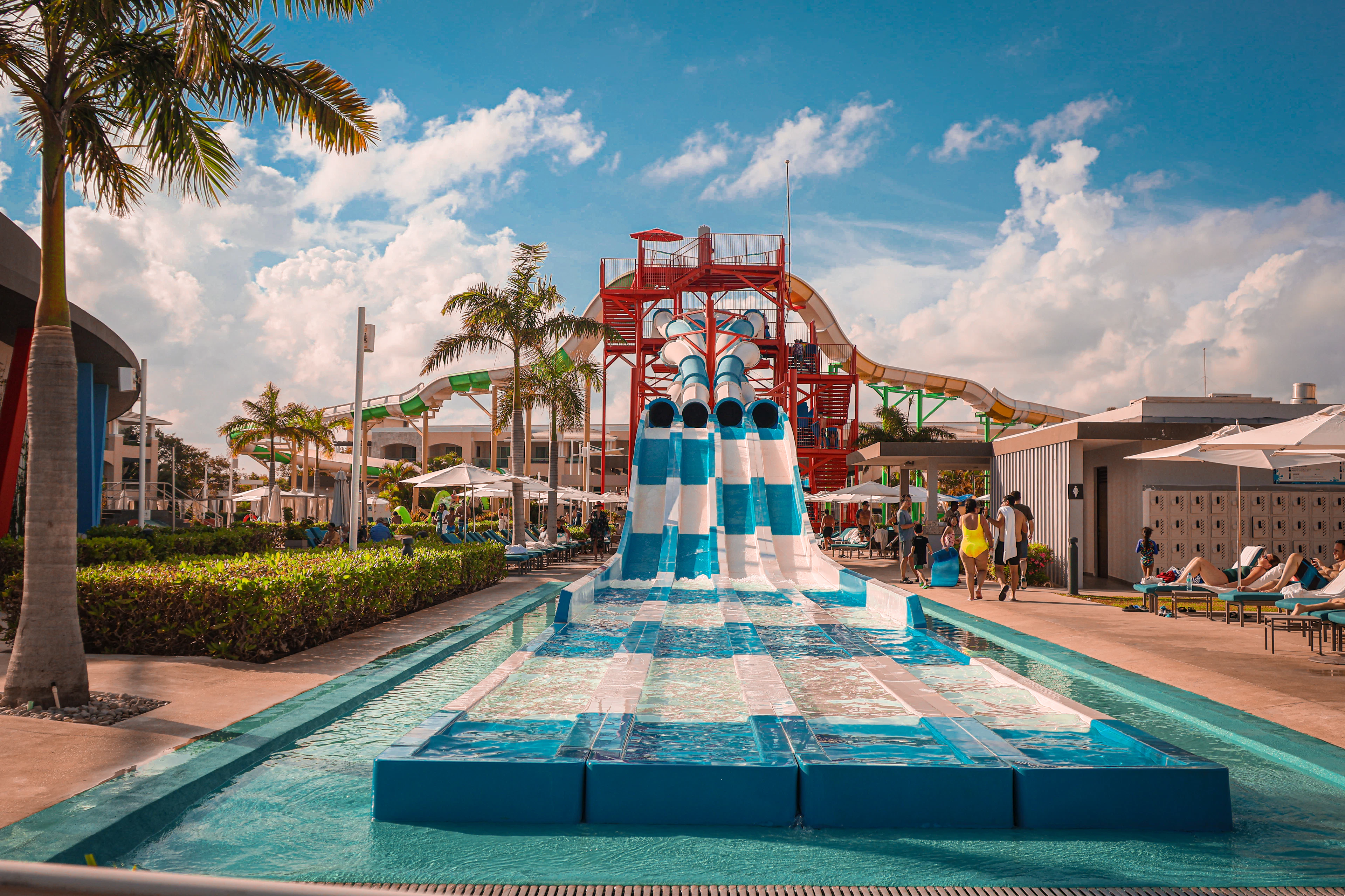 Water slides and a swimming pool at a tropical outdoor water park