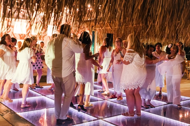 A group of people standing on top of a dance floor