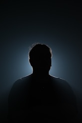 A silhouette of a man in the dark
