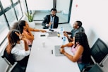 A group of people sitting around a white table