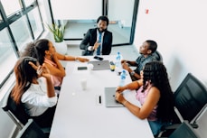 A group of people sitting around a white table