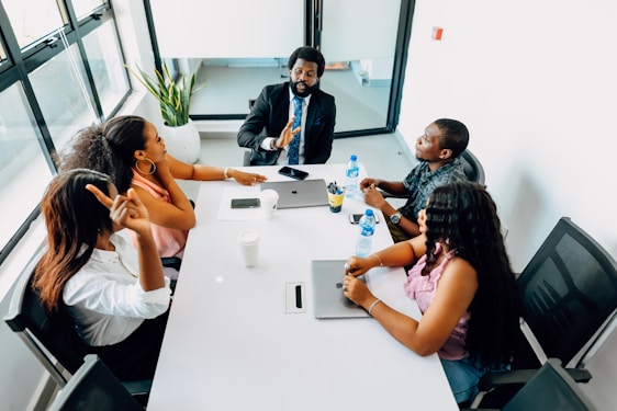 A group of people sitting around a white table