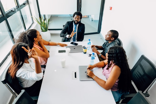 A group of people sitting around a white table