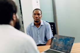 A man sitting in front of a laptop computer