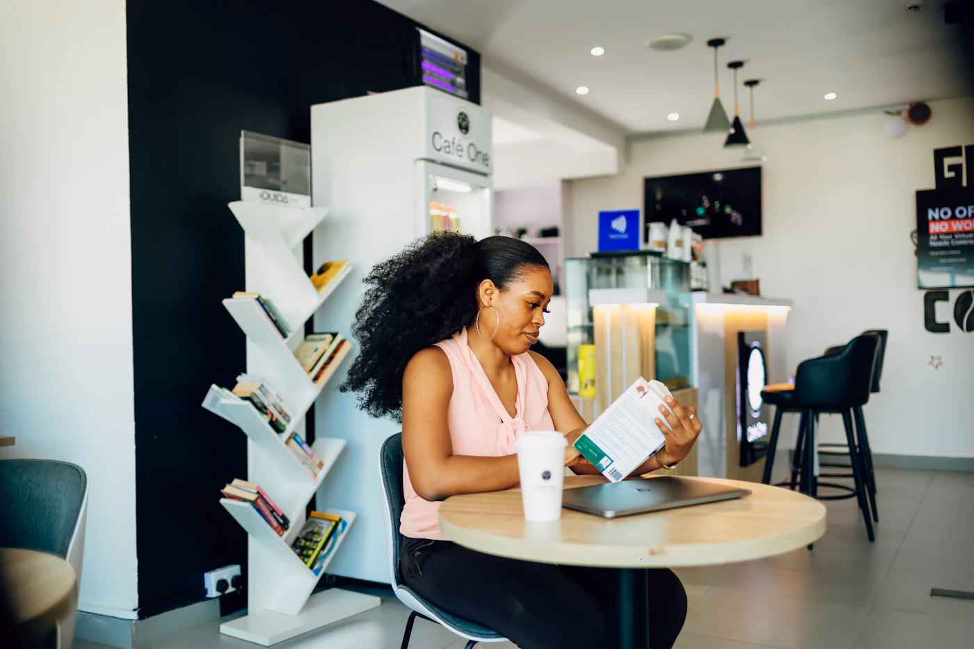 A woman sitting at a table working on a laptop