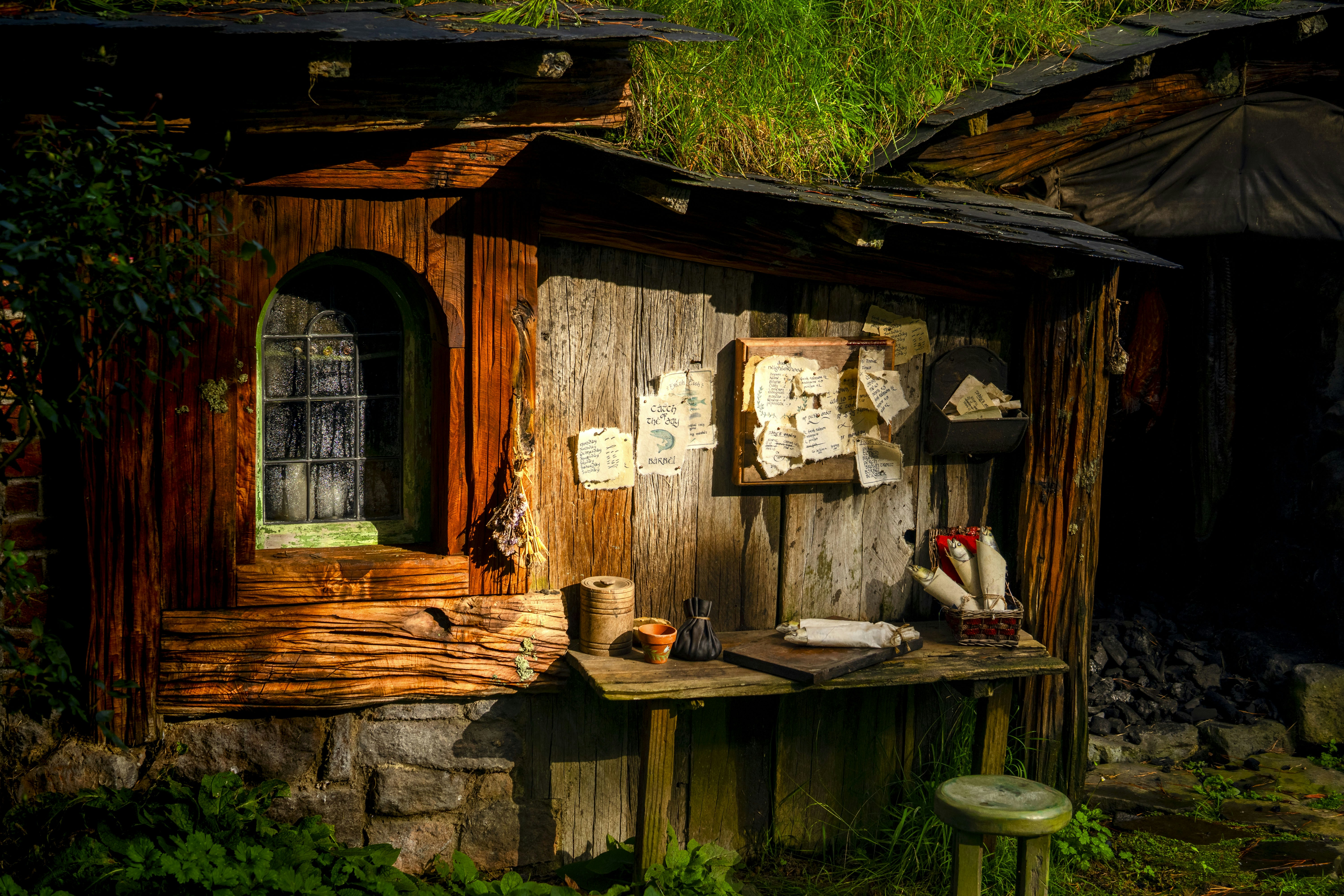 A small wooden cabin with a green roof