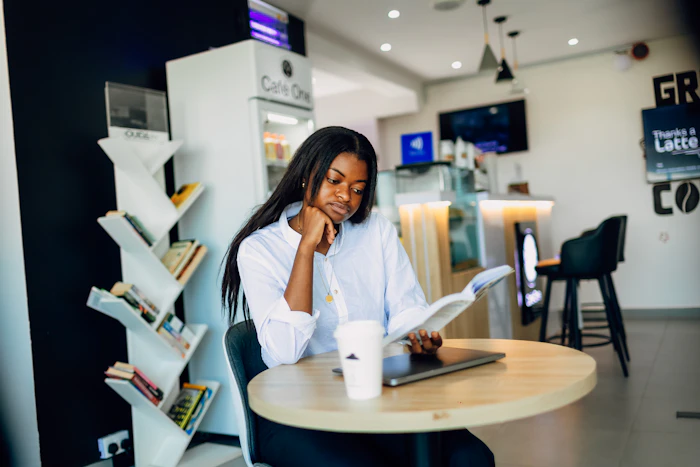A businesswoman working on a laptop at a desk